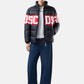 Piumino Corto Uomo Gcds Tessuto tecnico, costruzione trapuntata, imbottitura, collo alto, chiusura frontale con zip, tasche laterali, fascia logo a contrasto, fondo e polsi elasticizzati Band Logo Puffer Jacket Z0MLQA110T258